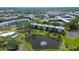 Aerial view of the community showcasing lush landscaping, a tranquil lake, and well-maintained buildings at 5920 80Th N St # 107, St Petersburg, FL 33709