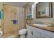 Bathroom with a shower and a vanity with sink and mirror offering modern fixtures and a clean, functional design at 5920 80Th N St # 107, St Petersburg, FL 33709