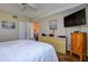 Cozy bedroom with a comfortable bed, complemented by a dresser, and a mounted TV for relaxed viewing at 5920 80Th N St # 107, St Petersburg, FL 33709