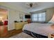 Comfortable bedroom featuring a ceiling fan and plush gray carpeting, complete with a modern TV and dresser at 5920 80Th N St # 107, St Petersburg, FL 33709