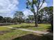 Expansive green space with mature trees and a serene pond for a peaceful, picturesque community setting at 5920 80Th N St # 107, St Petersburg, FL 33709