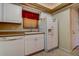 Bright kitchen featuring white appliances and cabinetry, with a window overlooking the outdoors at 5920 80Th N St # 107, St Petersburg, FL 33709