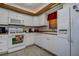 Efficient kitchen featuring white cabinetry, appliances, and tiled flooring at 5920 80Th N St # 107, St Petersburg, FL 33709