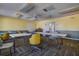 Large meeting room with tan carpeting and a combination of rolling and stationary chairs at 5920 80Th N St # 107, St Petersburg, FL 33709