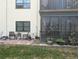 Charming patio seating area with brick pavers leading to a screened-in porch and views of the community grounds at 5920 80Th N St # 107, St Petersburg, FL 33709
