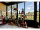 Enclosed sunroom filled with plants, offering a serene view of the outdoors at 5920 80Th N St # 107, St Petersburg, FL 33709