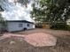 Expansive backyard featuring a circular brick patio and ample space for outdoor activities at 6770 Ralston Beach Cir, Tampa, FL 33614