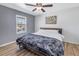 Inviting bedroom with a comfortable bed, ceiling fan, and a view of the outdoors at 6902 El Centro Ct, Tampa, FL 33634