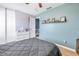 Cozy bedroom with a gray comforter on the bed and a dresser with white drawers at 6902 El Centro Ct, Tampa, FL 33634