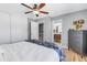 Cozy bedroom with ensuite bathroom featuring modern wood floors and gray color palette at 6902 El Centro Ct, Tampa, FL 33634