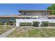 Back exterior view of townhome featuring fenced patio and well-maintained landscaping at 6902 El Centro Ct, Tampa, FL 33634