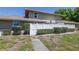 Back exterior of the house with a white fence surrounding the backyard and green landscaping at 6902 El Centro Ct, Tampa, FL 33634