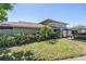 Charming home exterior with a lush, landscaped front yard and convenient carport at 6902 El Centro Ct, Tampa, FL 33634