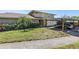 Inviting townhome featuring a covered carport, verdant landscaping, and a well-maintained lawn at 6902 El Centro Ct, Tampa, FL 33634