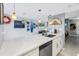 Modern kitchen with a spacious island featuring a stainless steel dishwasher and sink at 6902 El Centro Ct, Tampa, FL 33634