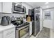 Modern kitchen featuring stainless steel appliances, sleek countertops, and ample cabinet space at 6902 El Centro Ct, Tampa, FL 33634