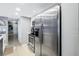 Stainless steel refrigerator adjacent to an electric oven and microwave, with white cabinets at 6902 El Centro Ct, Tampa, FL 33634