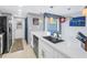 Modern kitchen with a spacious island featuring a stainless steel dishwasher and sink at 6902 El Centro Ct, Tampa, FL 33634