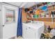 Laundry room featuring a side-by-side washer and dryer with storage shelves above at 6902 El Centro Ct, Tampa, FL 33634
