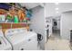 Laundry room next to a kitchen area featuring a washer and dryer at 6902 El Centro Ct, Tampa, FL 33634
