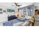 Comfortable living room with plush sofa, modern ceiling fan, and view of outdoor space at 6902 El Centro Ct, Tampa, FL 33634