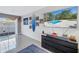 Bright living room with a view to the outside patio showcasing a modern media center at 6902 El Centro Ct, Tampa, FL 33634