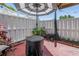 Outdoor patio with a small round table covered in black and a striped umbrella at 6902 El Centro Ct, Tampa, FL 33634