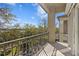 Condo balcony with metal railing overlooking a green space and a peek of a nearby building at 732 Coral Reef Dr # 732, Tampa, FL 33602
