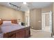 Bedroom with a wooden bed, ceiling fan, and track lighting, providing a warm and cozy ambiance at 732 Coral Reef Dr # 732, Tampa, FL 33602
