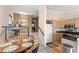 Dining area and open kitchen featuring wood cabinets and granite counters at 732 Coral Reef Dr # 732, Tampa, FL 33602