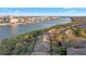 Aerial view showcasing waterfront residences surrounded by lush trees, with the city skyline in the background at 732 Coral Reef Dr # 732, Tampa, FL 33602