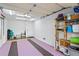 Spacious garage with painted floor, storage shelving, and ample room for parking and storage at 732 Coral Reef Dr # 732, Tampa, FL 33602