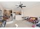 Open-concept living area featuring a ceiling fan, stairs with decorative railing, and views of the kitchen and dining area at 732 Coral Reef Dr # 732, Tampa, FL 33602