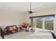 Large living room featuring a ceiling fan, a balcony with views, and a cozy atmosphere at 732 Coral Reef Dr # 732, Tampa, FL 33602