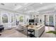 Bright living room with hardwood floors, coffered ceilings, and doors to outdoor spaces at 732 Coral Reef Dr # 732, Tampa, FL 33602