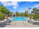 Luxurious swimming pool featuring a covered lounge area and city views, surrounded by manicured landscaping at 732 Coral Reef Dr # 732, Tampa, FL 33602