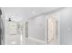 Bright hallway with sleek floors connecting the living room to other areas of the home at 7412 Gulf Breeze Cir, Hudson, FL 34667