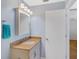 Bathroom features a granite countertop vanity with a decorative towel rack and a framed mirror above at 8457 Deauville # 8457, Pinellas Park, FL 33781