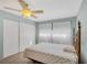 A comfortable bedroom includes a large closet and a window with sheer curtains for soft, natural light at 8457 Deauville # 8457, Pinellas Park, FL 33781