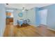 The dining room has hardwood floors, a ceiling fan and a wooden table set for four at 8457 Deauville # 8457, Pinellas Park, FL 33781