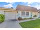 Attractive home with a garage, manicured lawn, and inviting curb appeal at 8457 Deauville # 8457, Pinellas Park, FL 33781