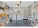 Spacious garage with washer, dryer, utility sink, storage shelves and a side door entry at 8457 Deauville # 8457, Pinellas Park, FL 33781