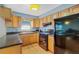 Efficient kitchen with wooden cabinets, black appliances, and natural light at 8457 Deauville # 8457, Pinellas Park, FL 33781