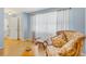 Bright living room with wood floors, large windows, and comfortable seating at 8457 Deauville # 8457, Pinellas Park, FL 33781