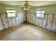 Bright bedroom featuring light-colored walls, two windows, a ceiling fan with lighting, and tile flooring at 8537 Horizon Ln, Hudson, FL 34667