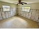 Bright bedroom with tile floors and two windows offers space and natural light at 8537 Horizon Ln, Hudson, FL 34667