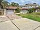 View of the exterior of a single story home with attached garage and driveway at 8537 Horizon Ln, Hudson, FL 34667