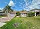 Charming single-story home with stone accents, a garage, and mature landscaping under a partly cloudy sky at 8537 Horizon Ln, Hudson, FL 34667