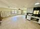 Bright kitchen with white cabinets, tile flooring, and plenty of room for dining and entertaining at 8537 Horizon Ln, Hudson, FL 34667