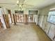 Spacious living room with tile floors, exposed framing, light-colored walls, and ample natural light at 8537 Horizon Ln, Hudson, FL 34667